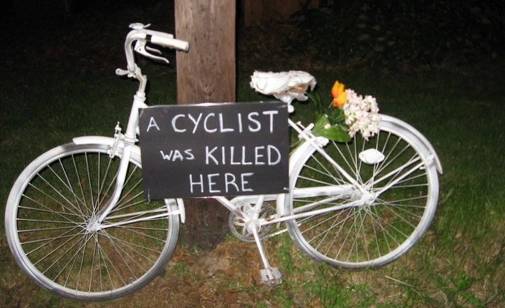 Ghost Bike with sign "A Cyclist Was Killed Here"