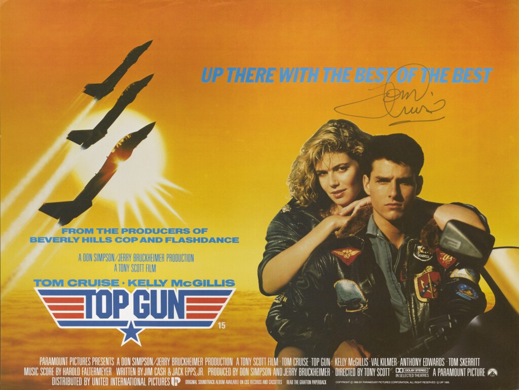 Poster for Top Gun. The foreground right is Tom Cruise and Kelly McGillis sitting on a motorcycle. Surrounding them are the credits and tagline for the movie. The background shows three fighter jets in silhouette flying in front of the sun.