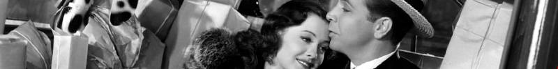 Ellen Drew & Dick Powell leaning against each other in Christmas in July.