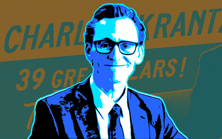 Tom Hiddleston as Chuck, smiling and wearing glasses