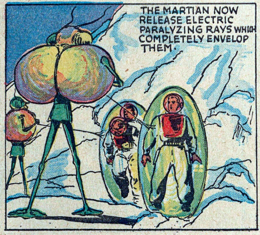 Comic book panel: Two aliens shooting beams at astronauts, surrounding them with green bubbles. Text reads "THE MARTIAN NOW RELEASE PARALYZING RAYS WHICH COMPLETELY ENVELOP THEM."