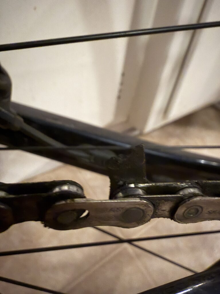 Close up of a broken link on a bike chain.