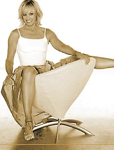 Susan Anton straddles a chair